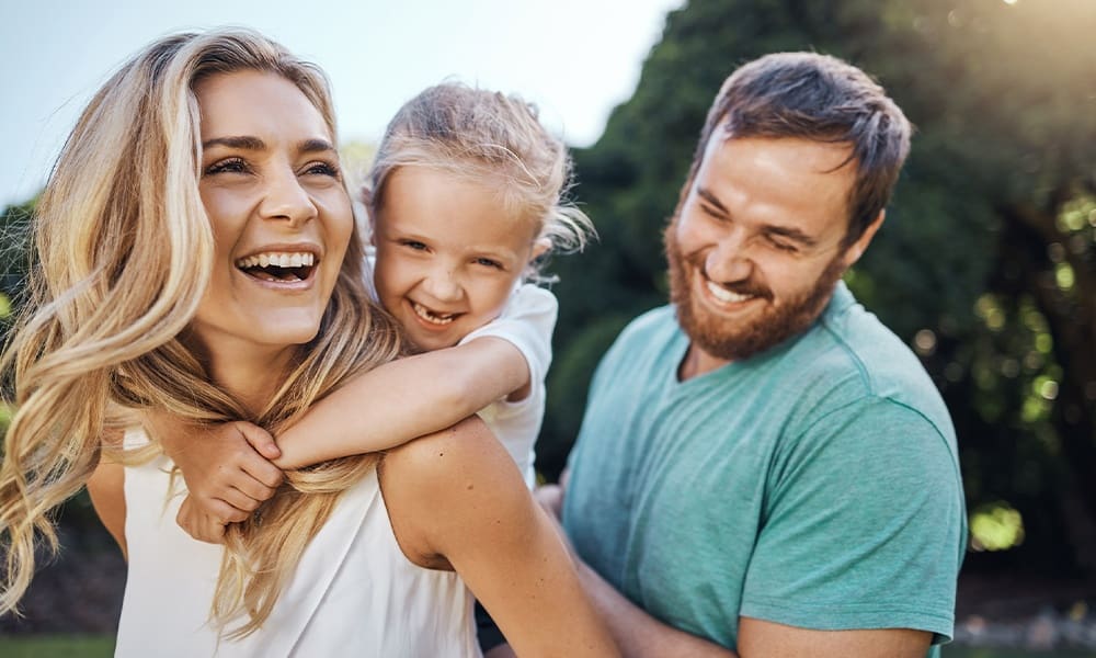 What to Expect From Group Life Insurance in Houston, TX - Love, Happy Family and Summer Nature With Child Bonding Together With Young Parents in the USA